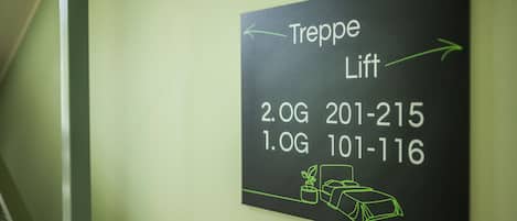 A sign with directions and phone numbers for the Treppe Lift.