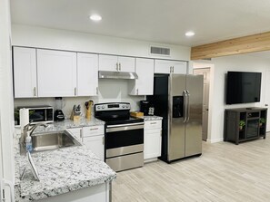 Enjoy cooking in this well-equipped kitchen with a microwave, stovetop, and refrigerator.