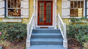 A two-story house with a red door, white shutters, and a number '25' on the front wall. - Uptown Charmer|1mile walk to DT|2miles Vilano BCH (Saint Augustine)