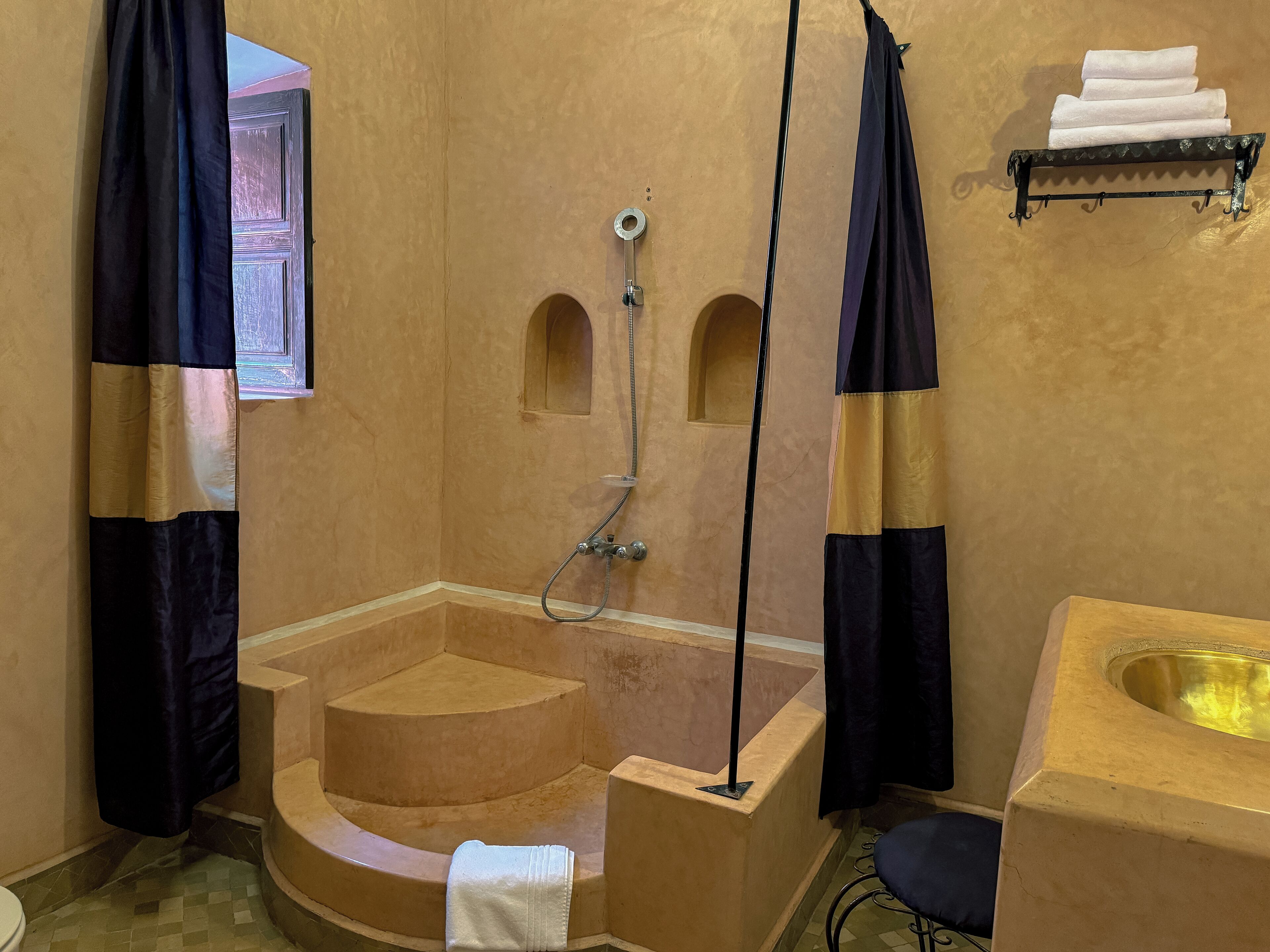 A bathroom with a bathtub, a shower, and a sink.