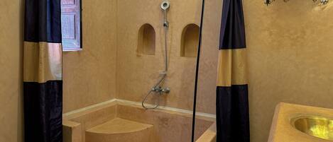 A bathroom with a bathtub, a shower, and a sink.