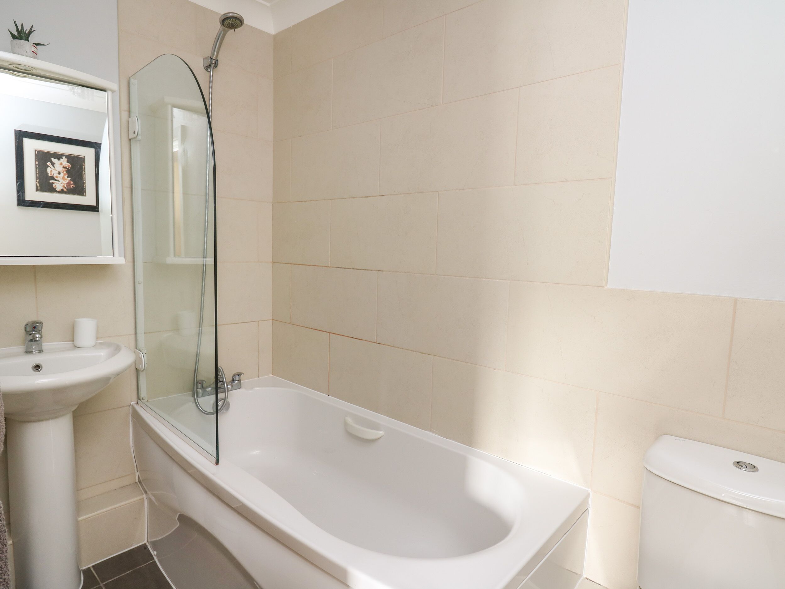 A bathroom with a bathtub, a sink, and a toilet.
