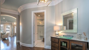 A modern bathroom with a glass shower, a vanity with a mirror, and a decorative sign. - Beach,Tons of entertainment, bikes, 2  golf carts, Golf, Amazing Gym, and Marina (Miramar Beach)
