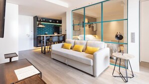 A modern living room with a sofa, a dining table, and a kitchen area in the background. - Home2Book Lovely Apartment in Santa Cruz (Santa Cruz de Tenerife)