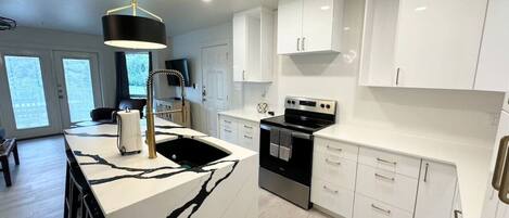 Fridge, microwave, coffee/tea maker, cookware/dishes/utensils