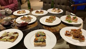 Une table à manger avec divers amuse-gueules et boissons.
