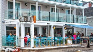 A restaurant with outdoor seating and a sign reading "STONES THROW".