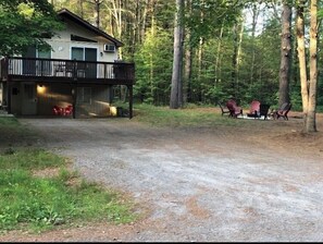 A cabin with a porch and outdoor seating. - The Cabin @Lake George (Lake George)