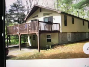 A two-story house with a balcony and a small porch. - The Cabin @Lake George (Lake George)