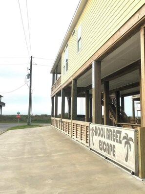 A building with a sign reading 'Kool Breeze Escape' and a covered outdoor area. - Kool Breeze Escape: 3 BR, 2 BA House in Port Bolivar, Sleeps 12 (Bolivar Peninsula)