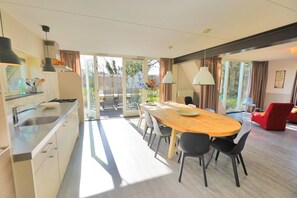 Enjoy meals in the spacious dining area with a large table and comfortable seating for all.
