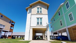 Un immeuble à plusieurs étages doté d’une entrée centrale, d’un espace abrité et d’un garage.
