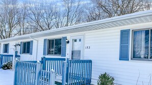 A row of mobile homes with blue shutters and a number '153' on the side.