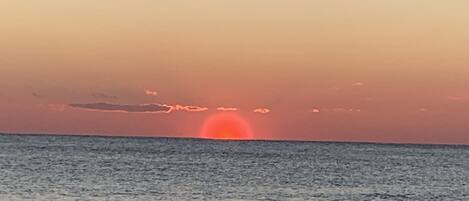 A sunset over the ocean with a clear horizon.