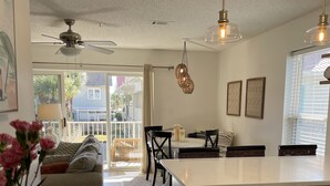 A modern kitchen with a central island, white cabinetry, and pendant lighting. - Welcome to Rollin Tide Villas in the heart of beautiful 30A. (Santa Rosa Beach)