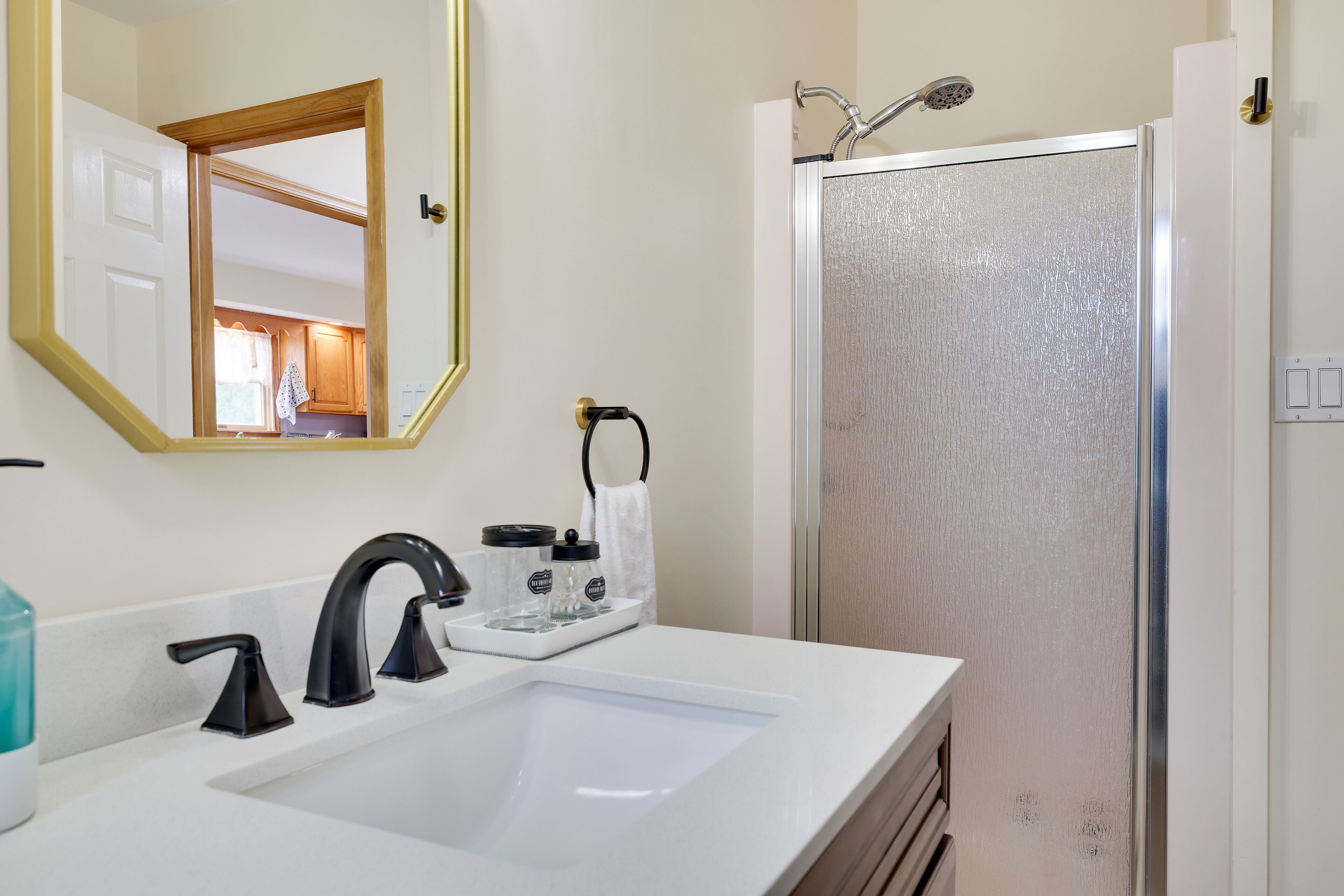 Bathroom #3 main level with a stand up shower and washer and dryer in the closet