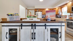 A kitchen with wooden cabinets, a marble countertop, and a built-in oven. - Private Heated Pool/Hot Tub/Huge Game Room/Sauna/Fire Pit/Huge Yard/3300 sq ft! (Stroudsburg)