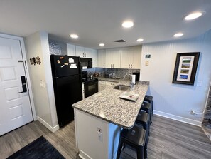 Enjoy cooking in this well-equipped kitchen with an oven, microwave, and sink.