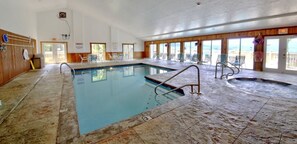 Relax by the pool with lounge chairs and a hot tub nearby.