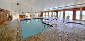 Relax by the pool with lounge chairs and a hot tub nearby.