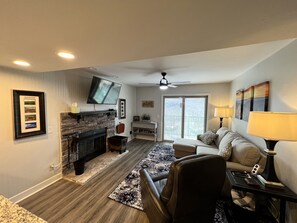 Cozy living space with a fireplace, flat-screen TV, and comfortable seating area.