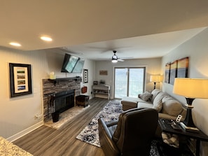 Cozy living space with a fireplace, flat-screen TV, and comfortable seating area.