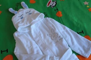 A white hoodie with a bunny design and the text "I love baby" on a green fabric with orange and white patterns. - Rightway Xiyue Hotel (Chengdu)