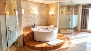 A modern bathroom with a freestanding bathtub, glass shower enclosure, and a marble floor. - Rightway Xiyue Hotel (Chengdu)