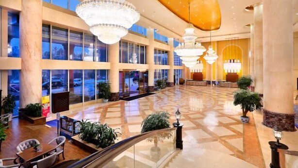 A spacious lobby with large chandeliers, marble columns, and a glass facade. - Rightway Xiyue Hotel (Chengdu)