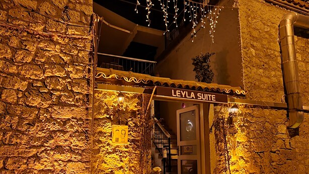 A stone building with a sign reading "LEYLA SUITE".