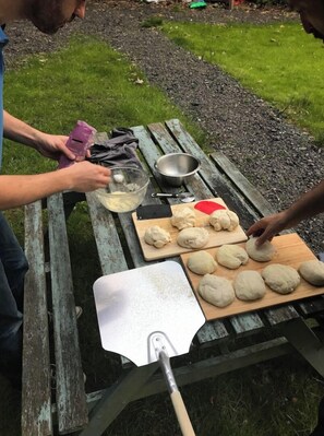 Enjoy a casual outdoor dining experience with a picnic table and cooking essentials at your fingertips.