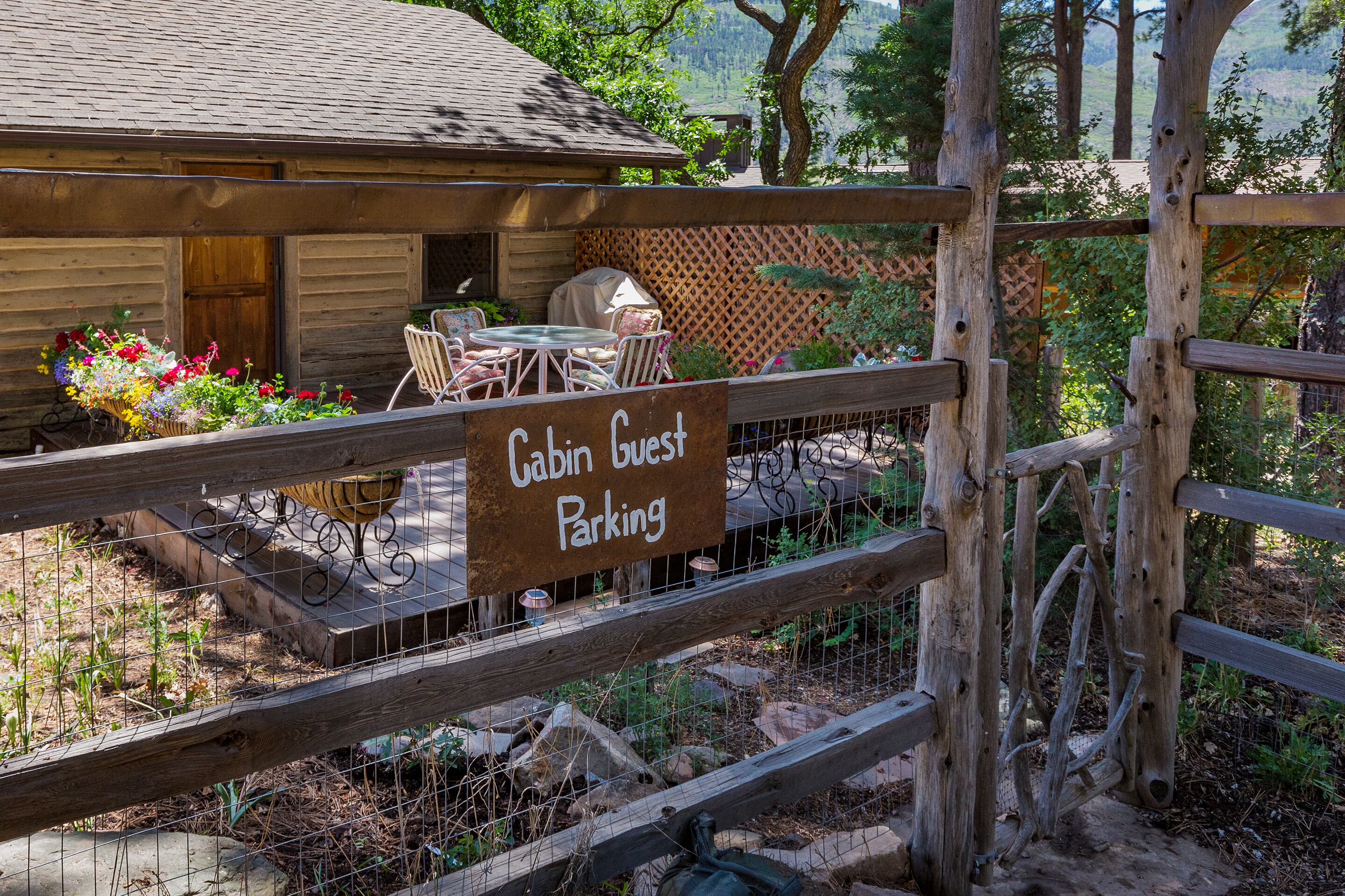 A cabin with a sign indicating "Cabin Guest Parking."