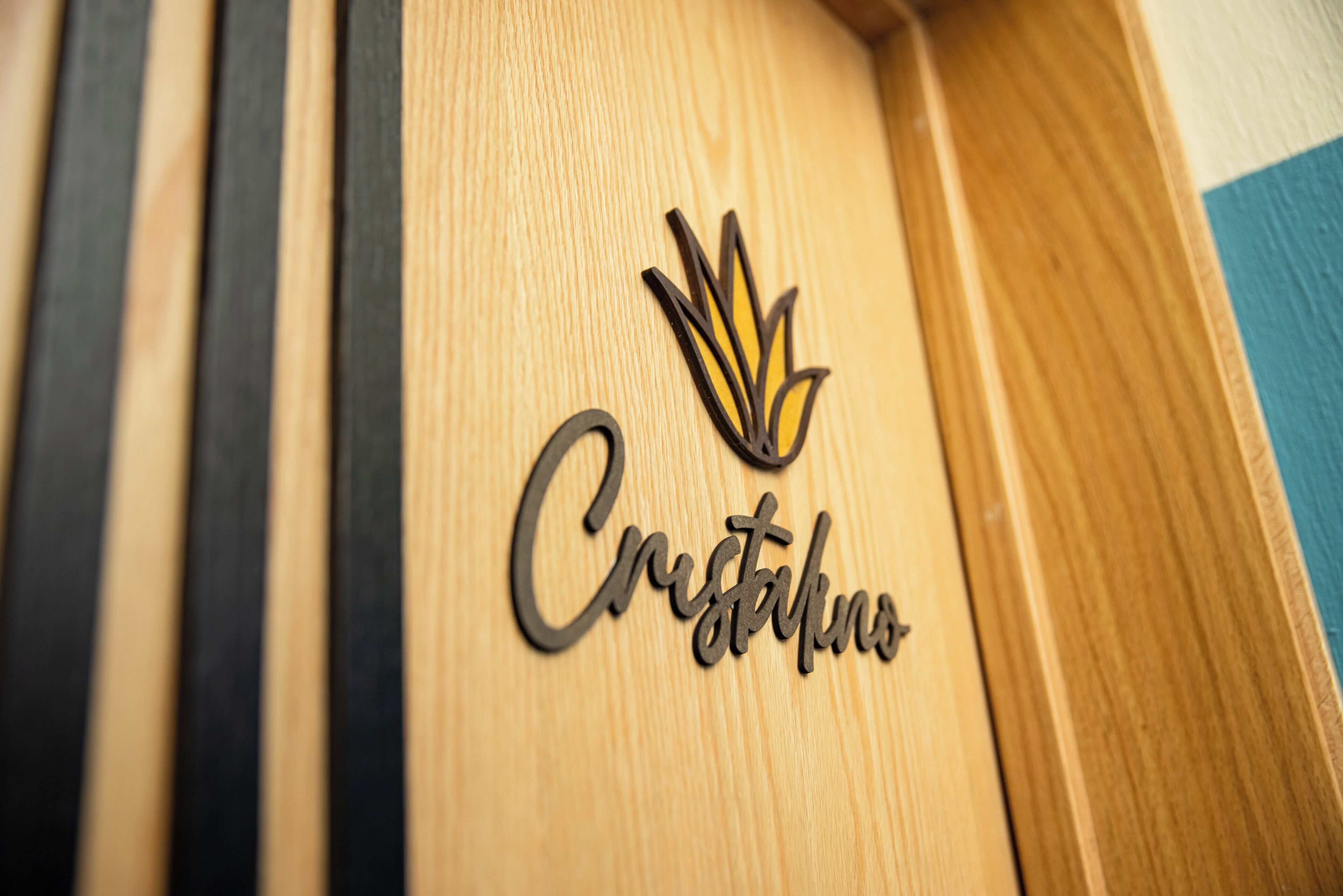 A wooden panel with a logo and the word 'Crystallo' engraved on it.