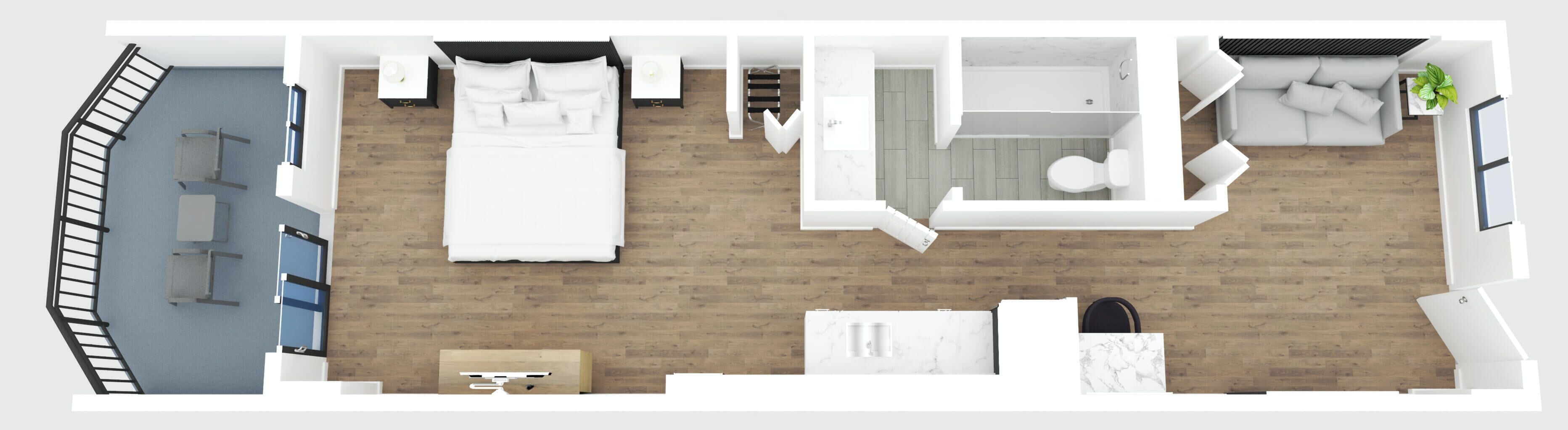 Et hotelværelse med seng, sofa, lille bord, skrivebord, badeværelse og trappe.
