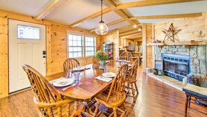 A wooden dining room with a large table and chairs, a stone fireplace, and a wooden ceiling. - Pet-Friendly Ellijay Escape w/ Yard & Grill! (Ellijay)