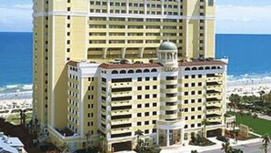 A multi-story hotel with a central dome and a beach view. - Spectacular Beach Condo Double Suite for 2 couples (Myrtle Beach)