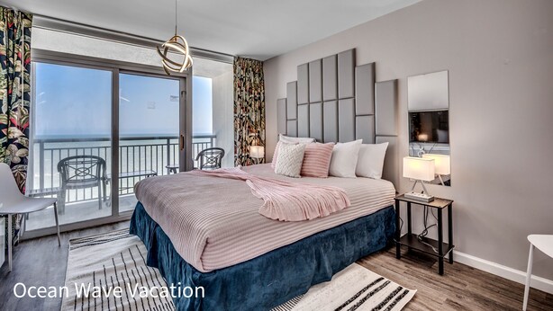 A bedroom with a large bed, a balcony with a view, and a modern design. - Spectacular Beach Condo Double Suite for 2 couples (Myrtle Beach)