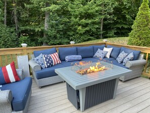 Relax on the outdoor deck with a sofa set and enjoy the warmth of the fire pit.