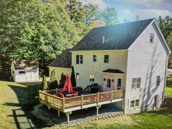 Enjoy the charm of this two-story house with a cozy porch and seating area.