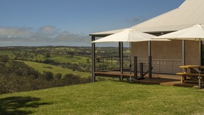A covered outdoor seating area with a view of rolling hills. - Old Coach Road Estate (Hindmarsh Valley)