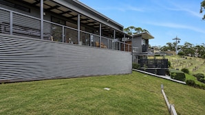 A modern building with a flat roof, large windows, and a covered outdoor area. - Top of the Bay by Ready Set Stay (Arthurs Seat)