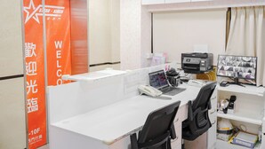 A hotel office with a cubicle, a desk with a computer, a printer, and a phone. - Star Ximen (Taipei)