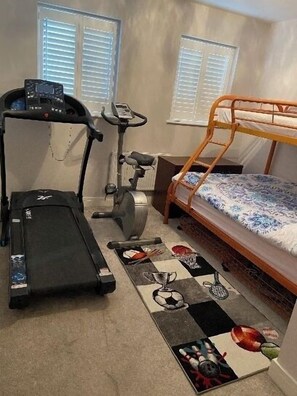 Sleep, stay fit, and add some personality to your stay with a compact room featuring a bunk bed, treadmill, and exercise bike.