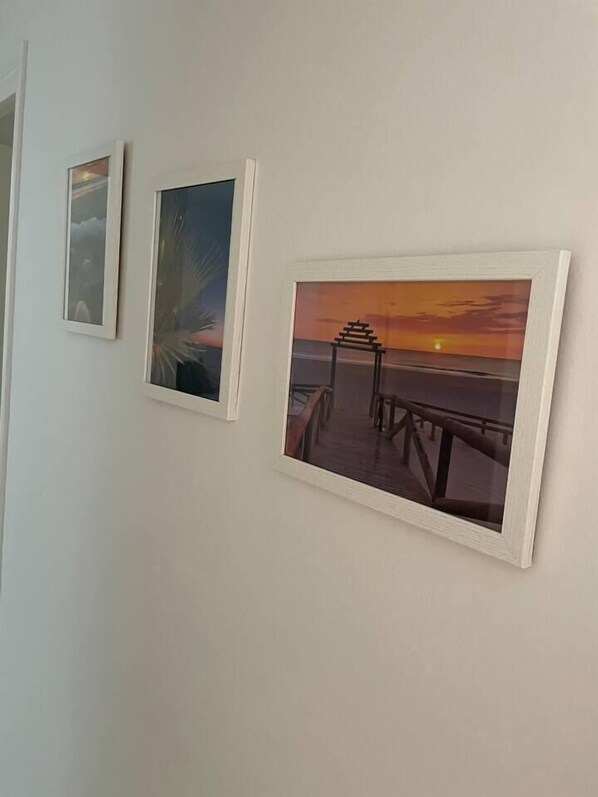 Three framed pictures on a wall.