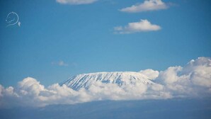 A snow-capped mountain under a clear sky.