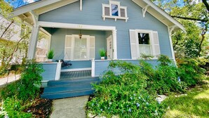 A two-story house with a porch, a garage, and a number '112' on the front. - Historic home, Heated Mini Pool, near downtown San Antonio! Walk to Zoo & Witte! (San Antonio)