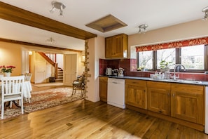 Enjoy cooking in this well-equipped kitchen with a large window and dining area.