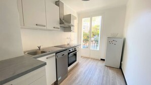 A modern kitchen with a dishwasher, oven, and a refrigerator. - Ajaccio: Appartement 3 pièces, 6 couchages, 600m de la plage, climatisé, centre-ville (Ajaccio)