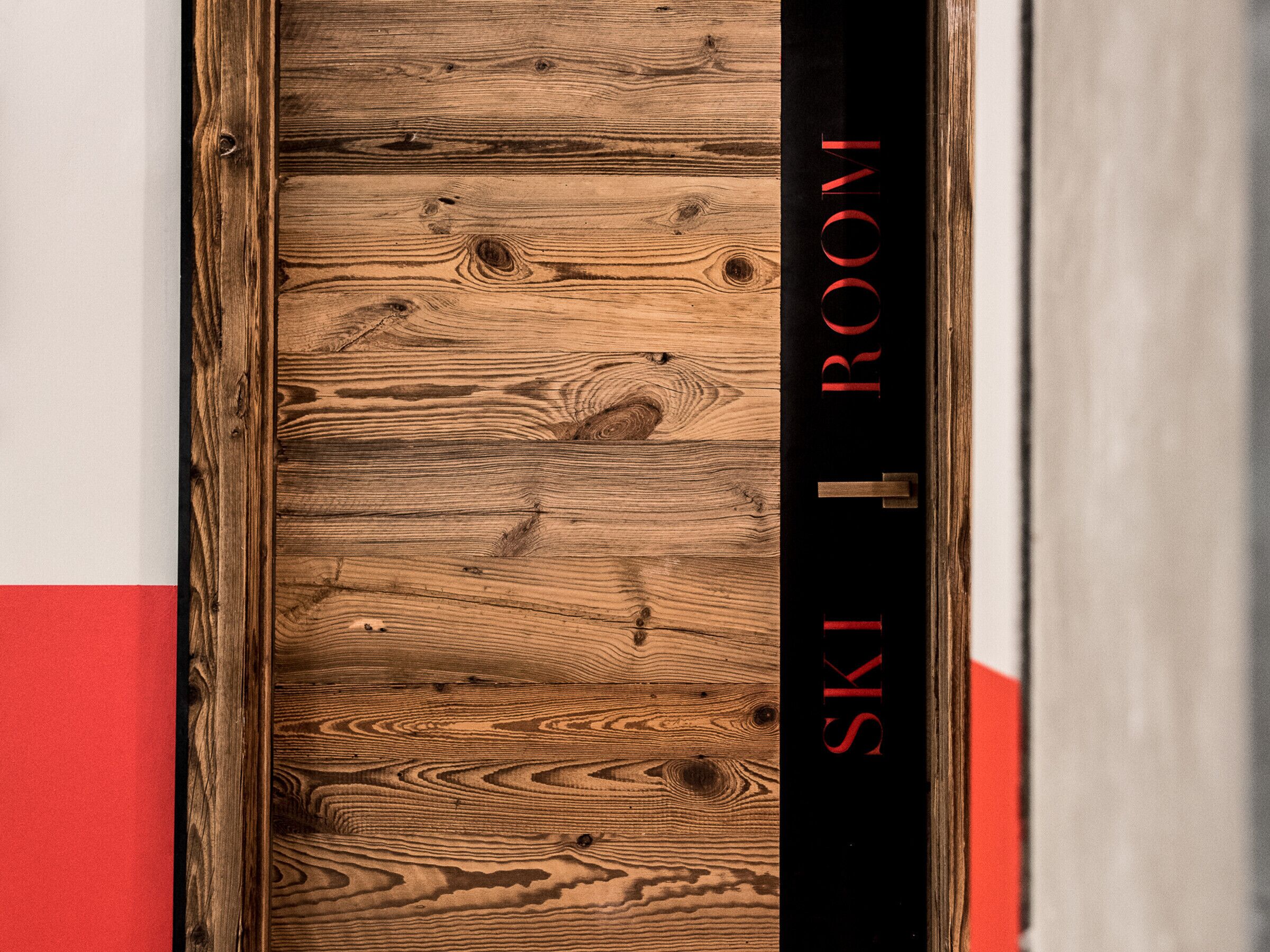 A wooden door with the text "SKI ROOM" on it.