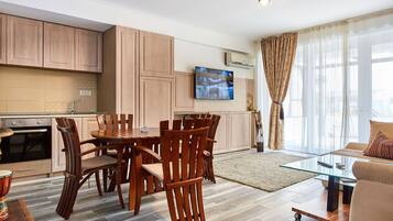 Luxury Apartment | Living area | 100-inch LED TV with satellite channels, TV